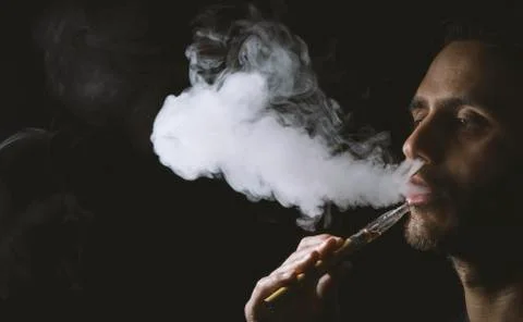 Holding vaping device or electronic cigarette Stock Photos