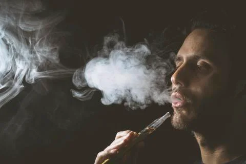 Holding vaping device or electronic cigarette Stock Photos