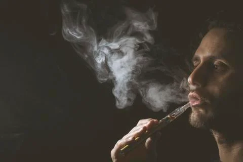 Holding vaping device or electronic cigarette Stock Photos