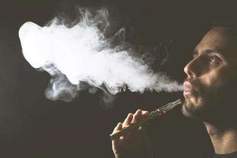 Holding vaping device or electronic cigarette Stock Photos