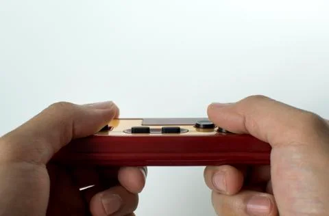 Holding a vintage computer game console Stockfoto's