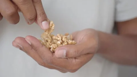 Holding walnuts in hand for cooking and baking Stock Footage 338155704