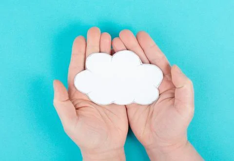 Holding a white cloud in the hand, empty copy space for text, blue background, 스톡 사진