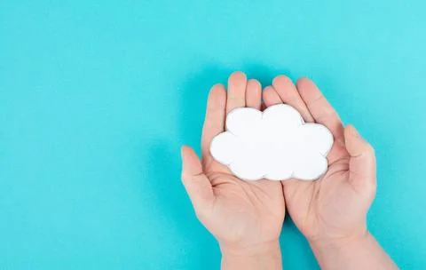Holding a white cloud in the hand, empty copy space for text, blue background, 스톡 사진