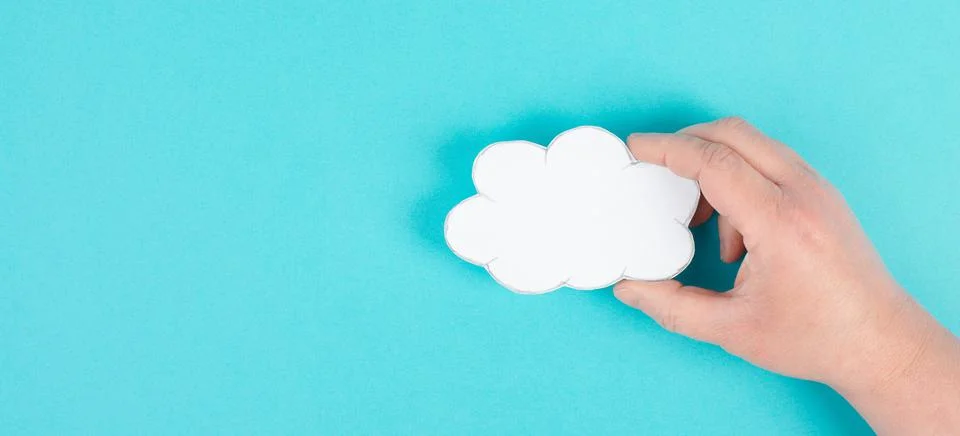 Holding a white cloud in the hand, empty copy space for text, blue background, 스톡 사진