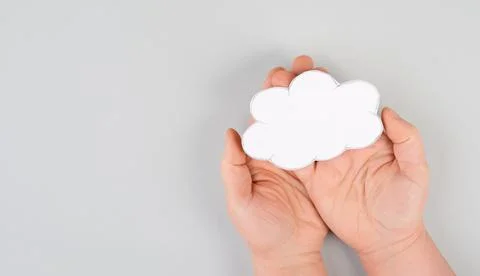 Holding a white cloud in the hand, empty copy space for text, gray background, Foto stock