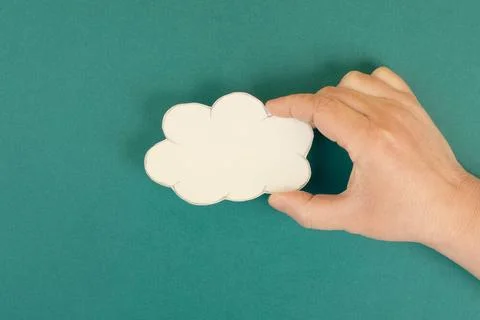 Holding a white cloud in the hand, empty copy space for text, green backgr... 스톡 사진