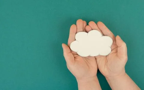 Holding a white cloud in the hand, empty copy space for text, green backgr... 스톡 사진