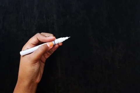 Holding White Marker in The Dark Stock Photos
