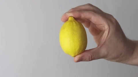 Holding whole lemon Stock Footage 323246247