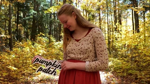 Holds Up words Pumpkin Patch in the Fall with Yellow Leaves 4K Video Stock Video stock 322102615