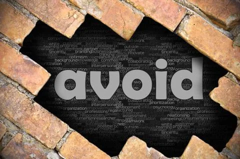 Hole in the brick wall with word avoid Foto stock