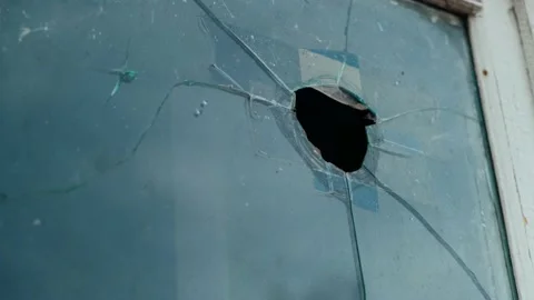 Hole in the broken window. Broken showcase in old building. Wooden white window Stock Footage 151925148