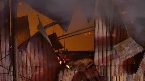 Hole in building with flames Stock Footage 103632343