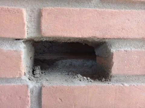 Hole with dry cement in the bricks Stock Photos