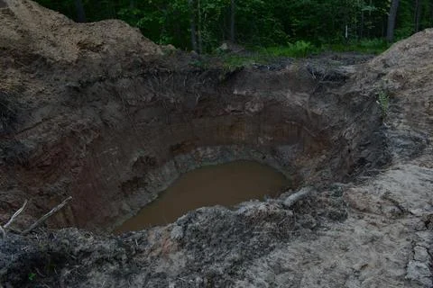 A hole dug in the forest Stock Photos