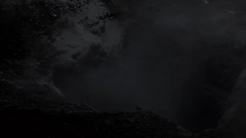 A hole in the ground from which ominous smoke or fog rises. Awesome black and Stock-Footage 287721291