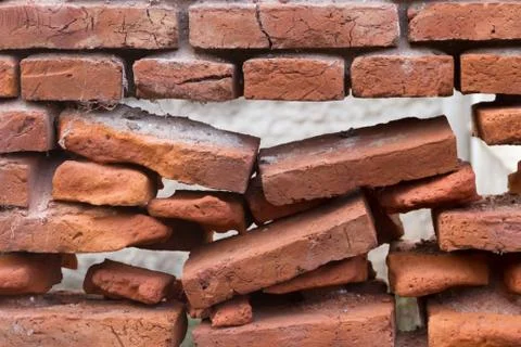 Hole in an old brick wall collapsing Stock Photos