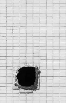 Hole on the old white wall Stock Photos