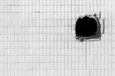 Hole on the old white wall Stock Photos