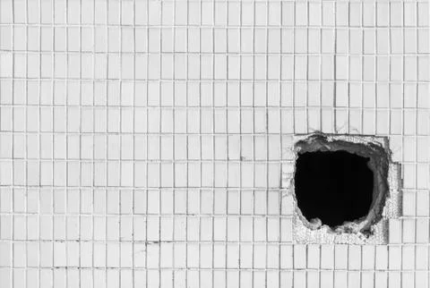 Hole on the old white wall Stock Photos
