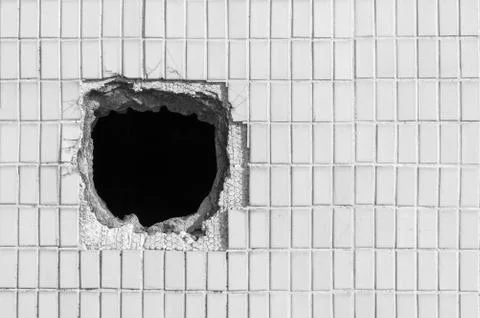 Hole on the old white wall Stock Photos