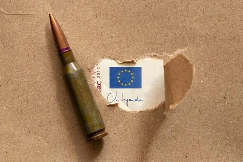 A hole in the paper through which the EU flag is visible on a ten euro note.. Stock Photos