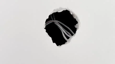 A hole in a plasterboard wall into which an electrical outlet will be insta.. Stock Footage 247022380