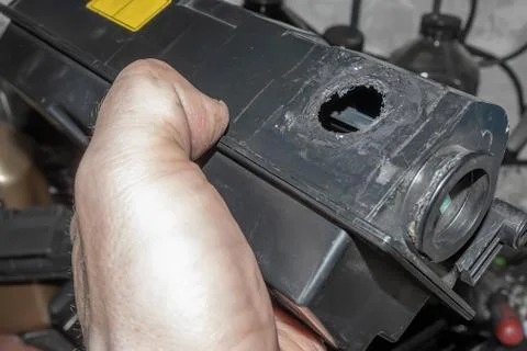 Hole from poor quality disassembly of the printer toner cartridge Stock Photos