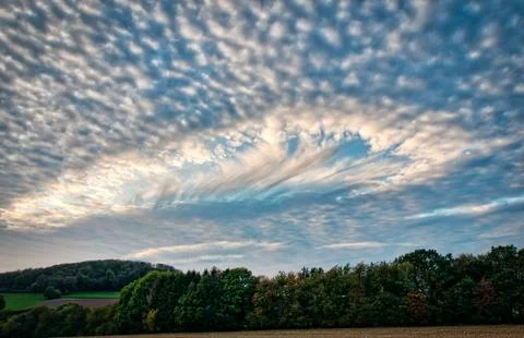 Hole punch cloud in the sky Stock Photos
