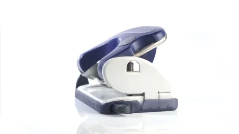 Hole Punch - Office Tool turning on isolated white Background Stock Footage 285600623
