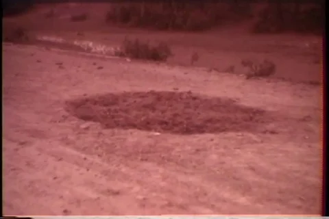 Hole in road from exploded mine - 1965 Video stock 89321742