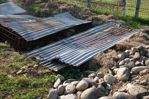A hole in the soil covered with random objects to mask the danger Stock Photos