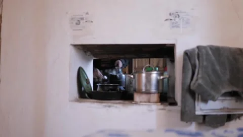 A hole through the open clay oven cooking breakfast. A village near Chernigov Stock Footage 272601583