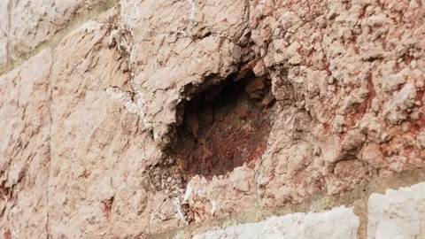 A hole in the wall from artillery fire during the war. Damage to a building f Stock Footage 218350105