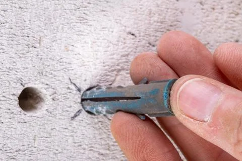 Hole in the wall, screw and dowel for fixing in concrete. Wall mounting metho Stock Photos