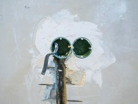 Hole in the wall under the socket Stock Photos