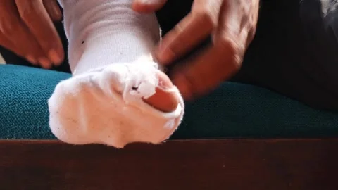 Hole in worn out sock Stock Footage 336706926
