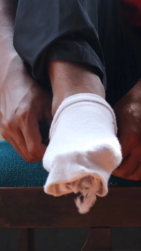 Hole in worn out sock Stock Footage 336706996