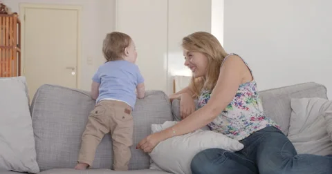 Holebi couple having fun with their baby in the couch- Stock Footage 48626287
