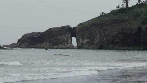 Holed cliff wall on the ocean Stockbeeldmateriaal 282112309