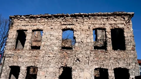 Holes of bullets and shells in the wall on the front line. Destroyed building. Stock Footage 233704016