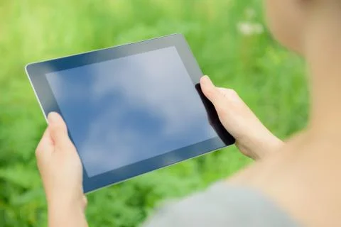 Holfing digital tablet in hands Stock Photos