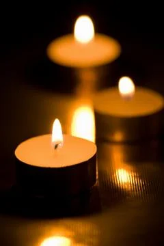 Holiday candles burning in the dark Stock Photos