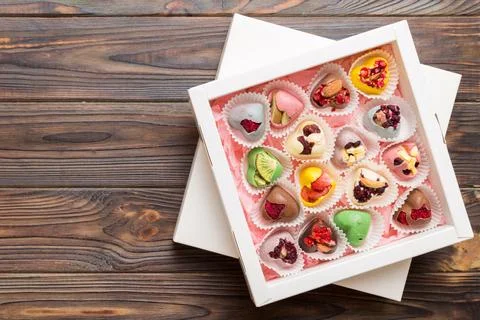 Holiday composition: sweet candy, with gift boxes with bow and chocolate he.. Stock Photos