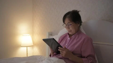 Holiday concept of 4k Resolution. An old Asian woman is interested in technol Stock Footage 146710066