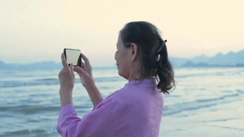 Holiday concept of 4k Resolution. An old Asian woman happily playing with a m Stock Footage 164172194