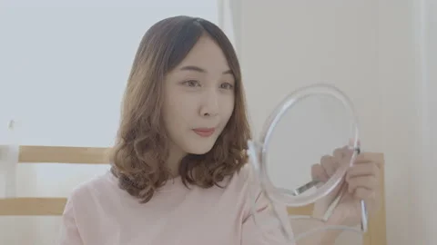 Holiday concept of 4k Resolution. Young Asian woman combing her hair in the b Stock Footage 198588581