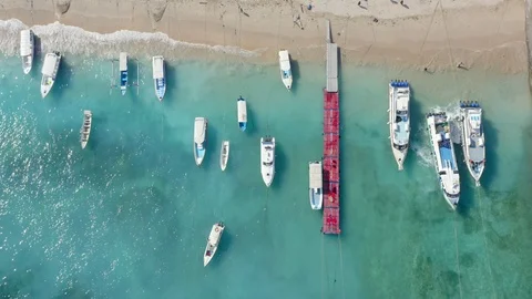 Holiday Concept. Beautiful Top Down Drone Shot of Ships on Toya Pakeh Harbour Stock Footage 113966479