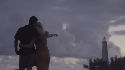 Holiday Couple Pointing at Lighthouse 스톡 동영상 287968821